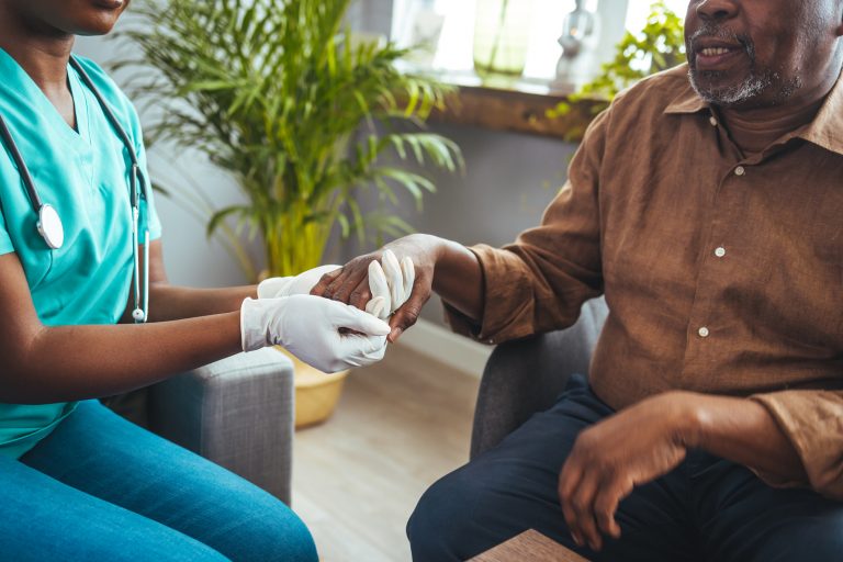 Nurse holding patient's hand for dementia care