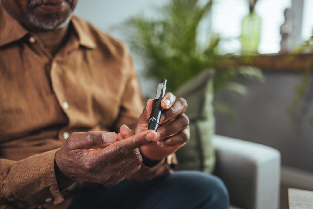 man with diabetes taking a blood test