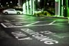 A parking lot only for electric vehicle charging seen during the night.