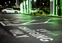 A parking lot only for electric vehicle charging seen during the night.