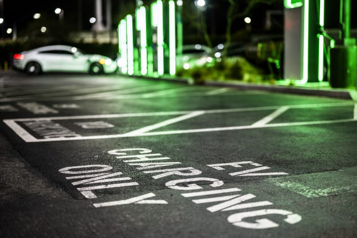 A parking lot only for electric vehicle charging seen during the night.