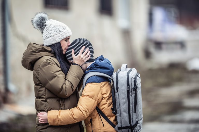 Woman kisses her boy