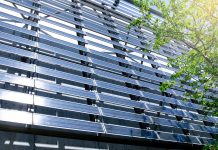 Solar Panel wall on Building with tree leaves