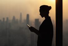 silouette of woman using a digital device