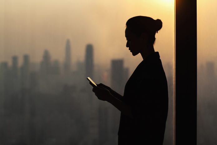 silouette of woman using a digital device