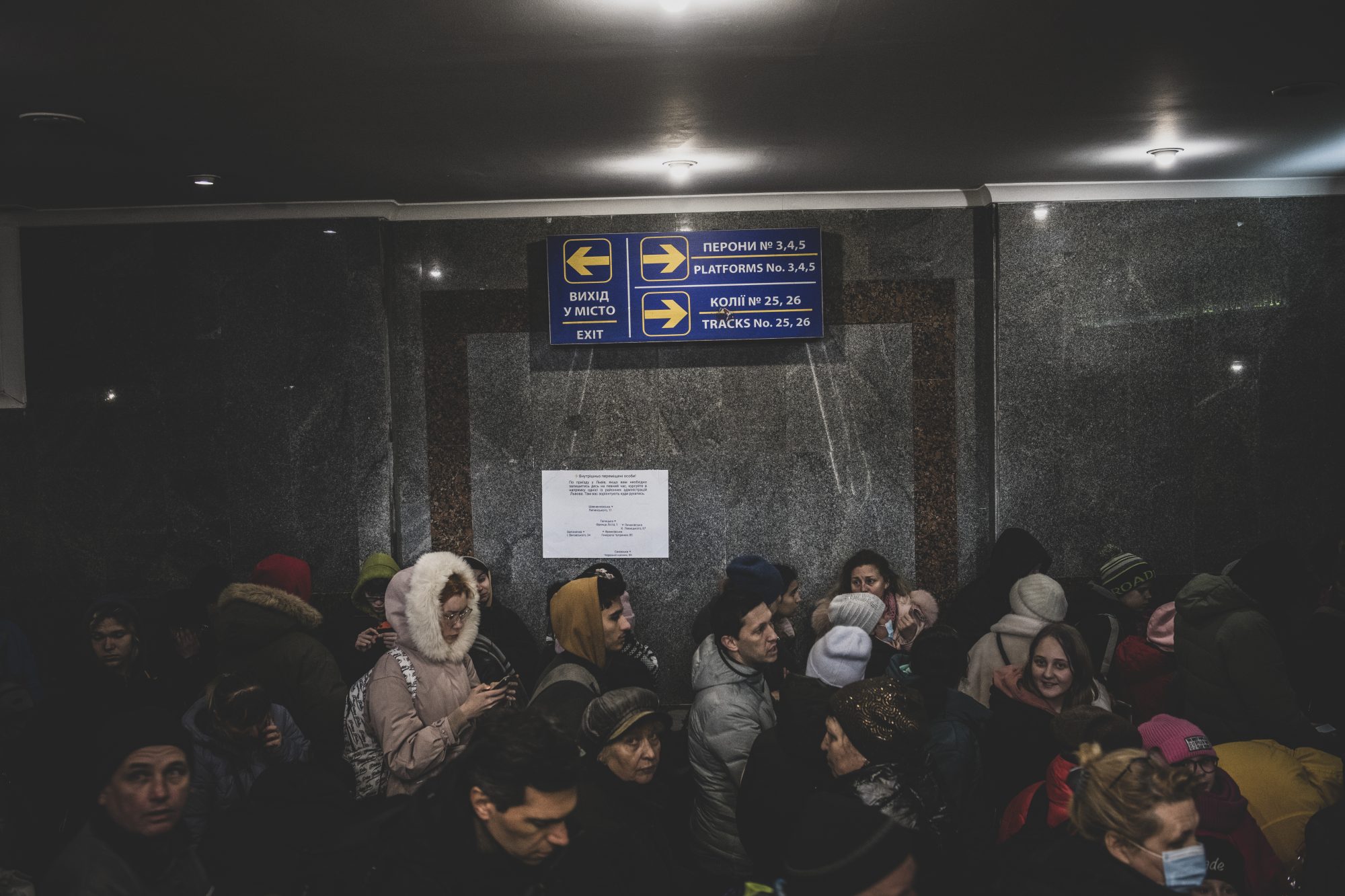 Lviv, Ukraine - March 3, 2022: A long line of people wait to board a train to Poland in Lviv, Ukraine.