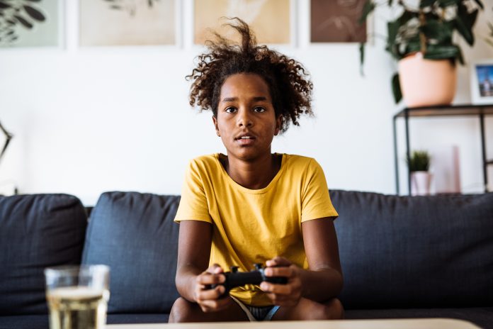 child playing on playstation at home