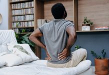 man with lower back pain in bed