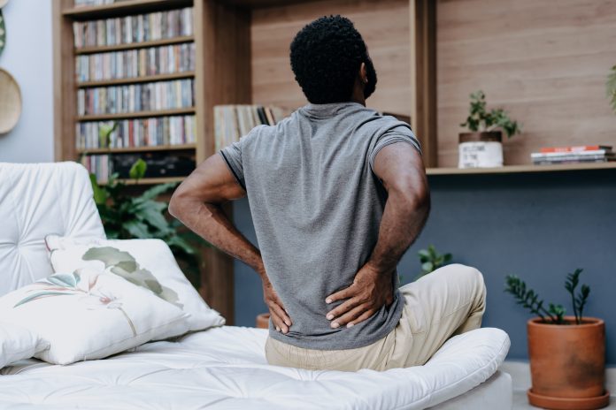 man with lower back pain in bed