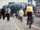 City workers walking and cycling over Waterloo Bridge at the end of the working day. Crash zoom effect done in camera.