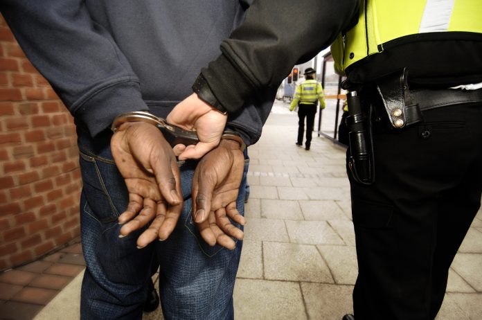 person being arrested by the police in the UK