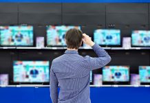 man looking at tvs when shopping