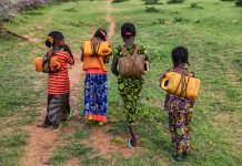 African girls carrying water from the well, Ethiopia, Africa