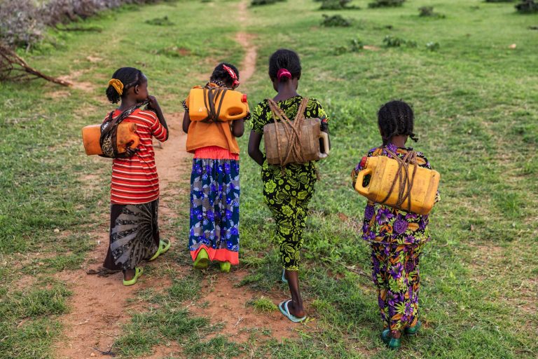 African girls carrying water from the well, Ethiopia, Africa