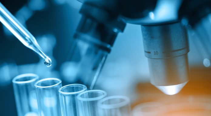 microscope with lab glassware, science laboratory research and development concept, representing HIV research and antiretroviral drugs