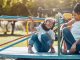 Shot of a mother and her daughter playing together on a merry-go-round at the park