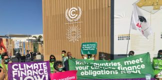 Climate activists emphasizing the urgency of climate finance at COP27