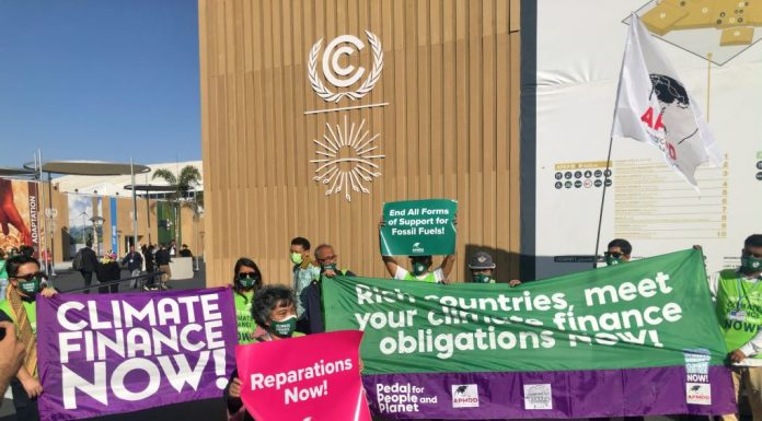 Climate activists emphasizing the urgency of climate finance at COP27