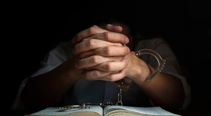 Handcuffs and the Holy Bible. Concept Picture of Someone Who Released From Sin by the God Words.