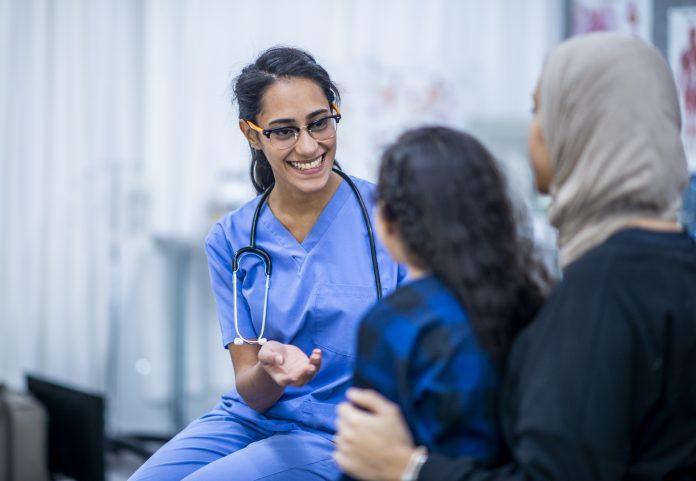 mother and daughter with a nurse in a Canadian hospital