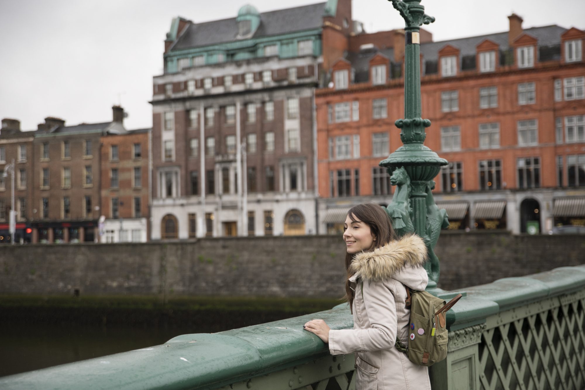 Woman looks over bridge in Dublin, Ireland