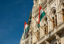 Hungarian flags on the Hungarian Parliament Building or Parliament of Budapest, a landmark and popular tourist destination in Budapest, Hungary