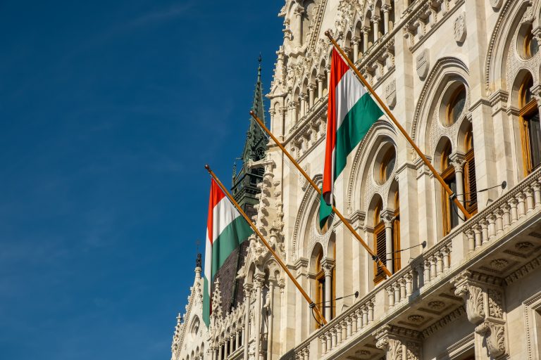 Hungarian flags on the Hungarian Parliament Building or Parliament of Budapest, a landmark and popular tourist destination in Budapest, Hungary