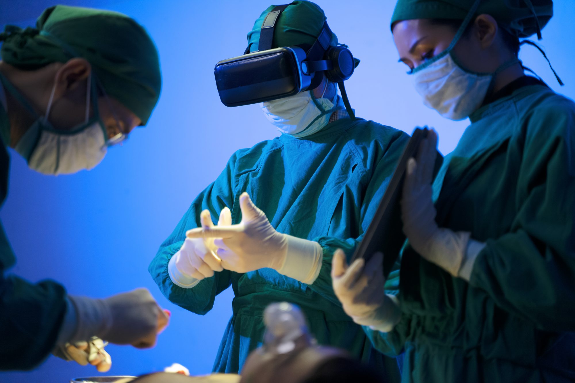 Doctors are surgery to patient at operating room. Using virtual reality glasses. Medical and health care concept.