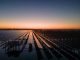 Early in the morning, the photovoltaic power station by the sea