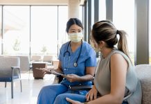 The mid adult female surgeon goes out to the waiting room to ask the young adult woman for information about the patient.