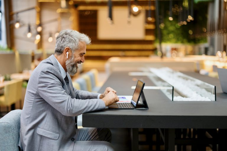 Businessman working in a lounge bar using digital tablet