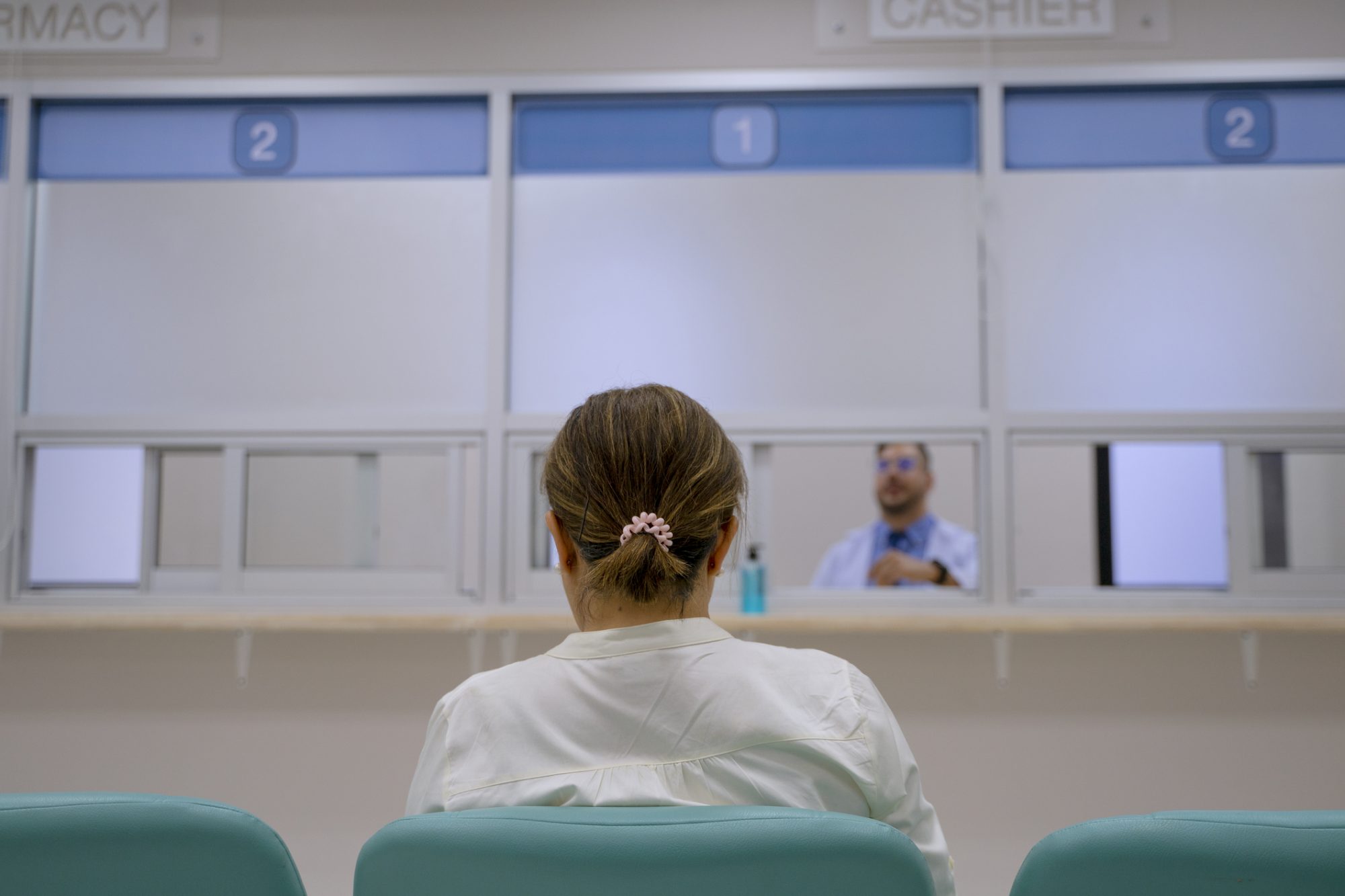 woman at a pharmacy waiting