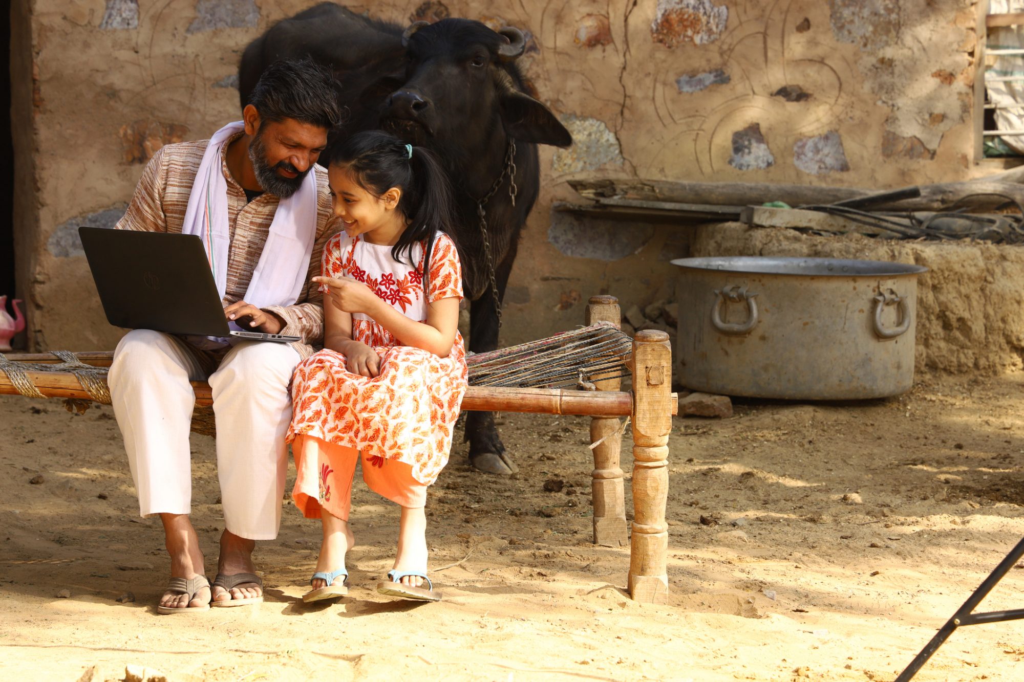 father showing daughter laptop