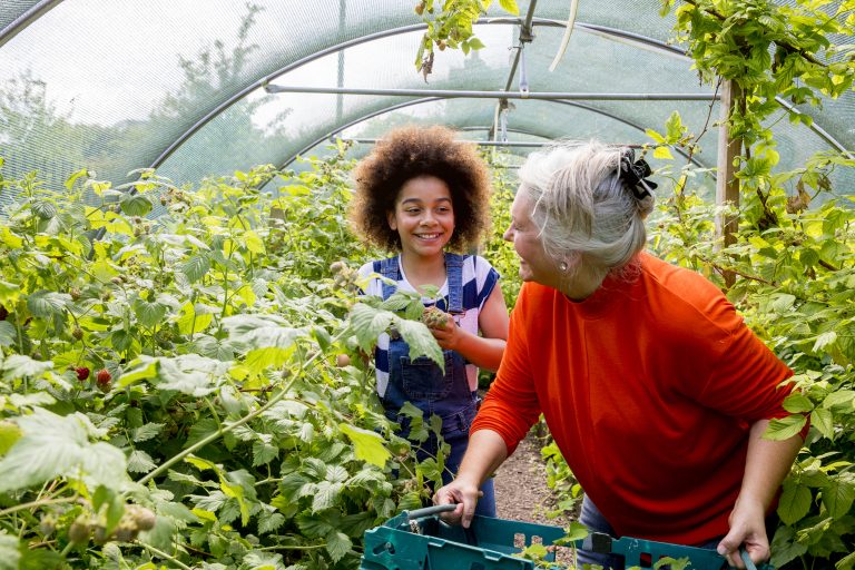 young girl volunteering in a garden