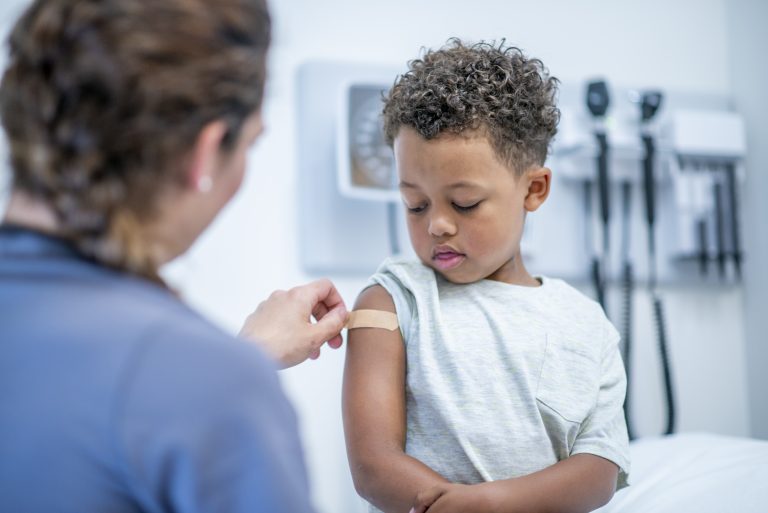 child being vaccinated against virus