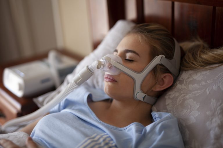 Cpap for Sleep Apnea on Woman in Bedroom