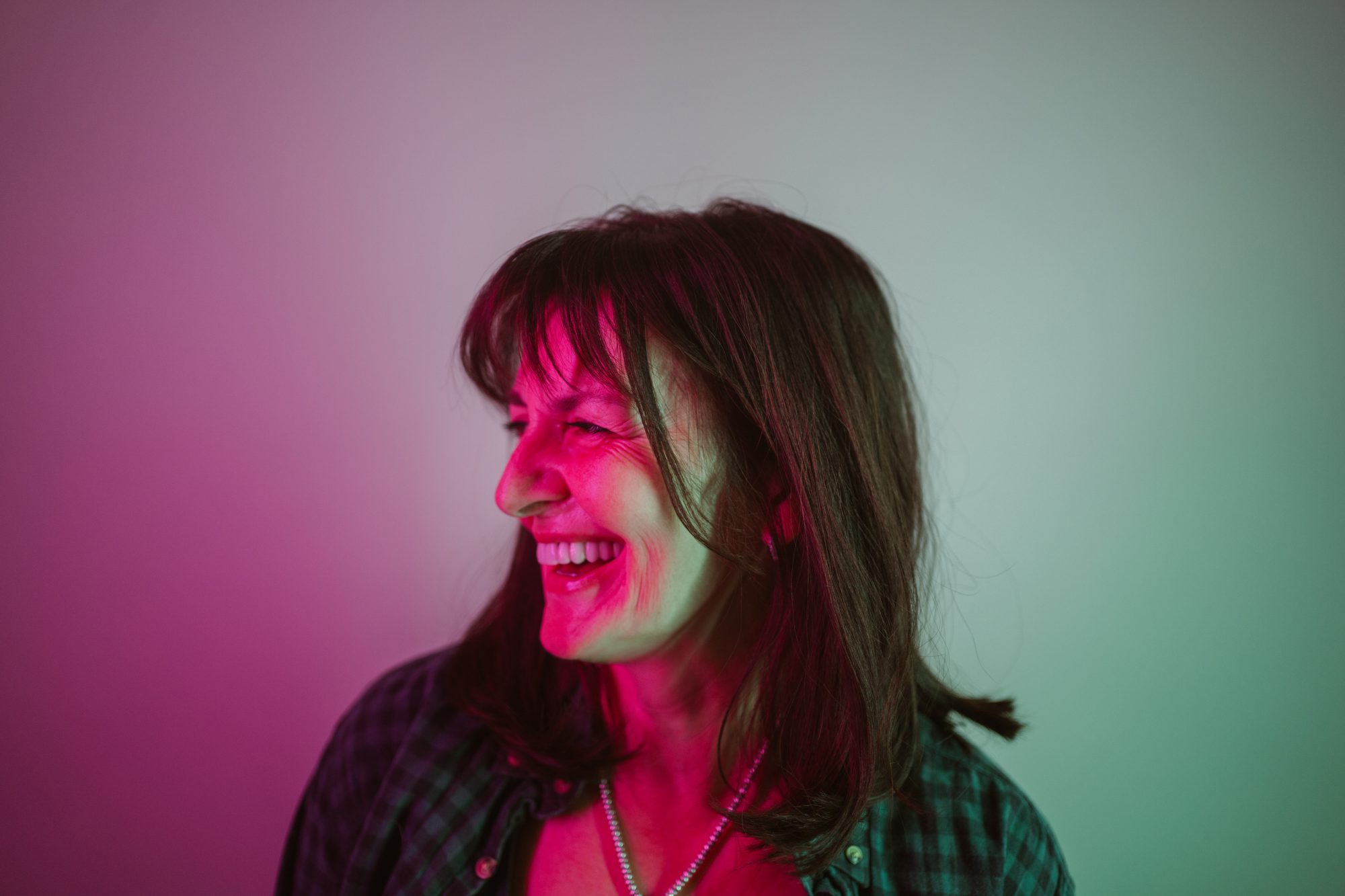 Portrait of a confident woman under neon lights