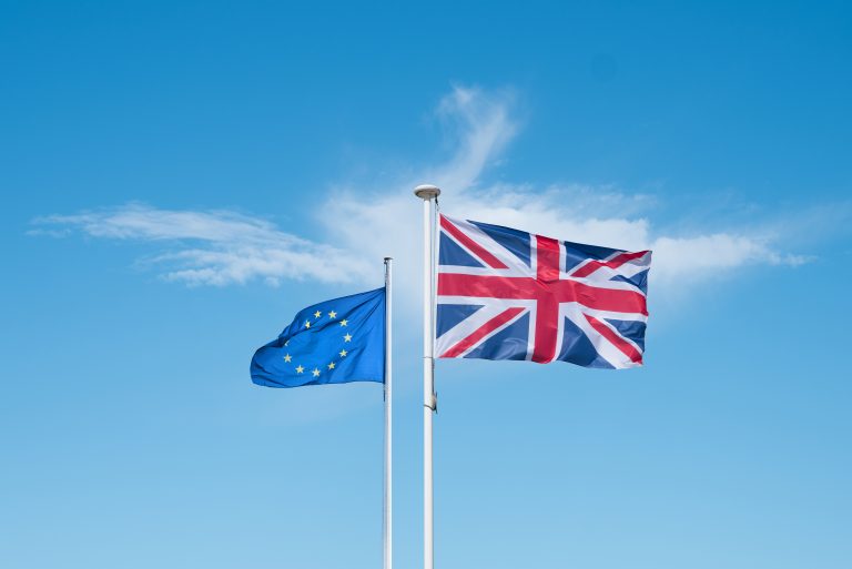 A European and English flag that flies at the top of a mast