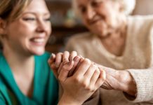 Cropped shot of a senior woman holding hands with a nurse