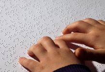 Young child reading braille