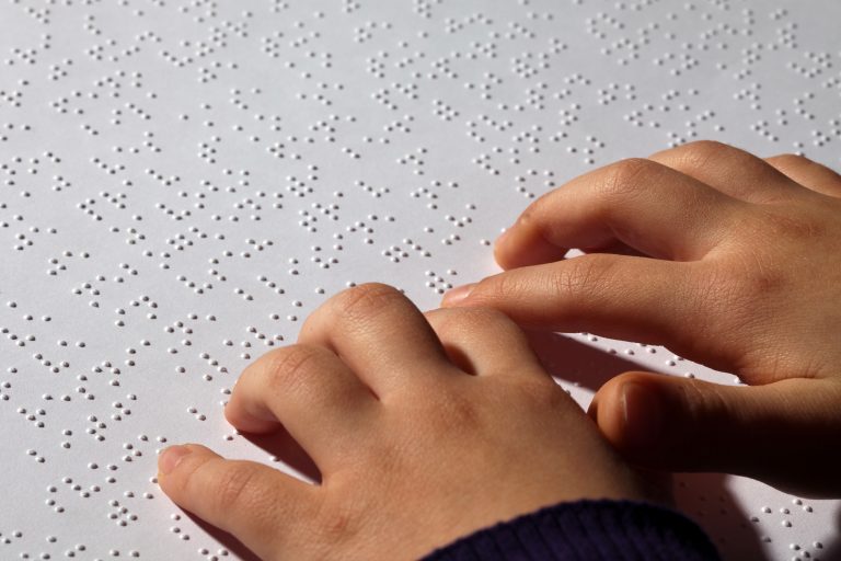Young child reading braille