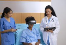 Doctor is going to visit patient with VR headset at hospital room.