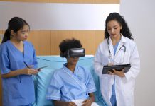 Doctor is going to visit patient with VR headset at hospital room.