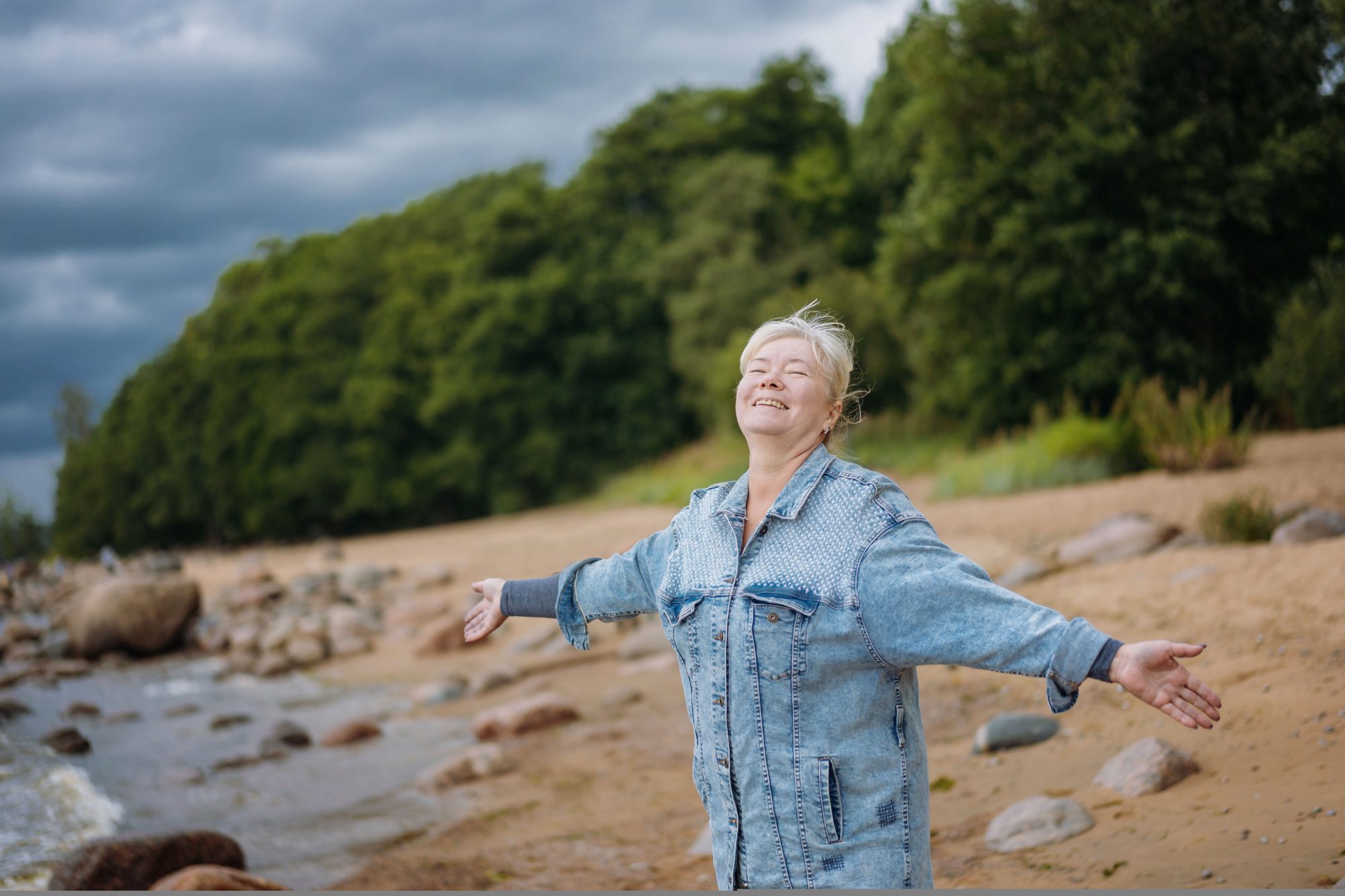 happy senior woman enjoying life and summer on the beach. High quality photo