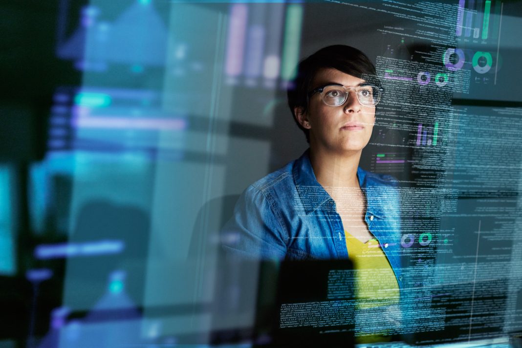 Cropped shot of a young computer programmer looking through data