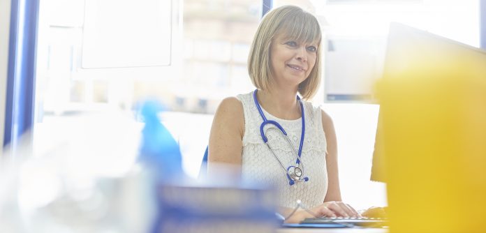 Female doctor working at her desk in her office