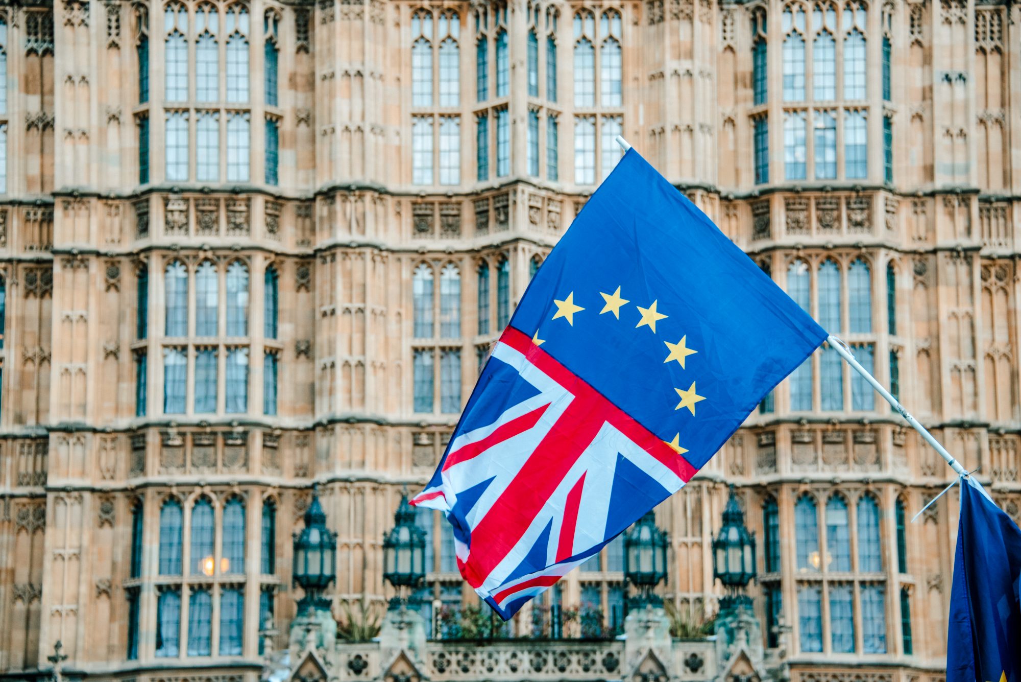 A flag merging the UK and EU flags, by Houses of Parliament building in London