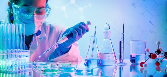 Chemistry Laboratory - Woman With Pipettes And Test Tubes