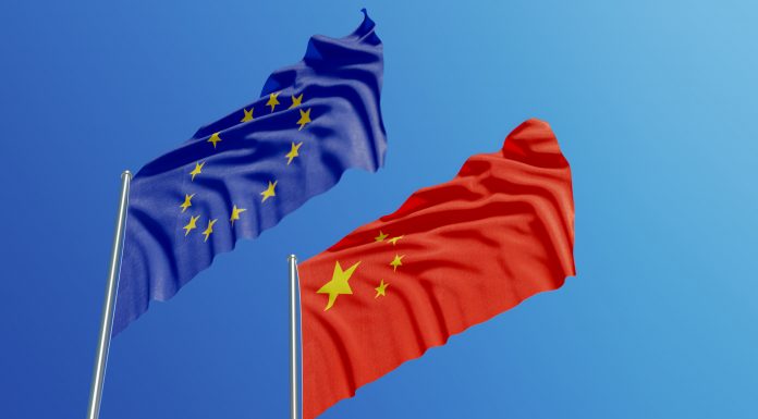 European Union and Chinese flags are waving with wind over blue sk, fostering international collaboration and personalised medicine