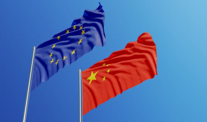 European Union and Chinese flags are waving with wind over blue sk, fostering international collaboration and personalised medicine